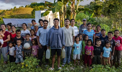 Sandi, Soleman, and Anjar, and families from Sandi’s village, in front of the water system they’ve designed in West Sumba, Indonesia_